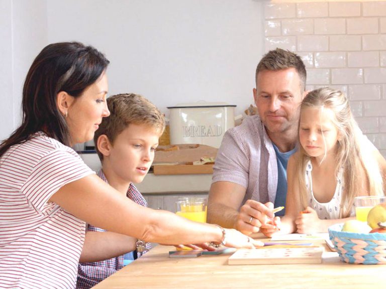 A family does an activity together at the table generational investing